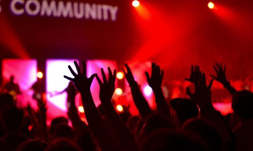 Independent musician networking at a music event to grow their music career through music industry connections.