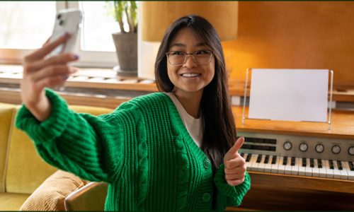 Musician creating micro-content for social media with smartphone and instruments