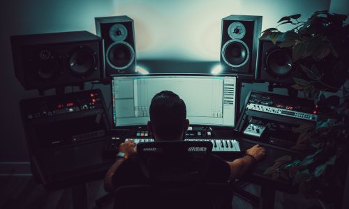 Producer working on music in a studio, creating a unique sound